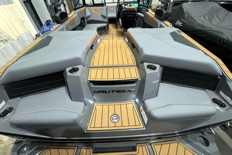 Slide: The Image of 2026 Nautique Super Air Nautique S21 interior with gray seating and wood accents. - 34