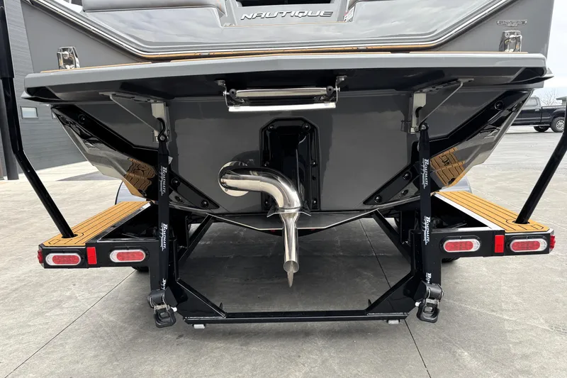 Slide: The Image of 2026 Nautique Super Air Nautique S21 boat rear view, showcasing sleek design and exhaust system. - 8