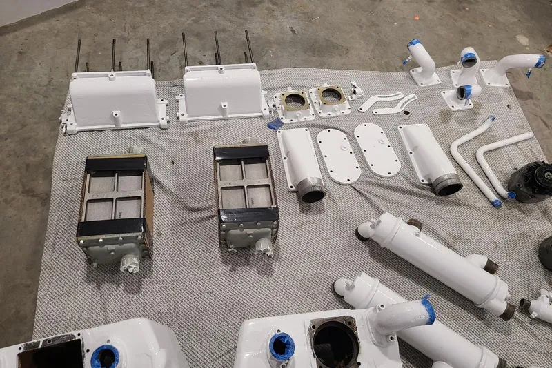 Slide: The Image of Various engine parts for a 1985 Post 43 Convertible boat displayed on a gray mat. - 18