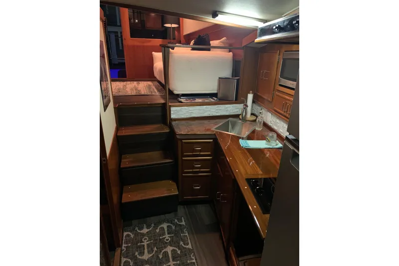 Slide: The Image of 1985 Post 43 Convertible yacht helm with marina view, featuring controls and steering wheel. - 7