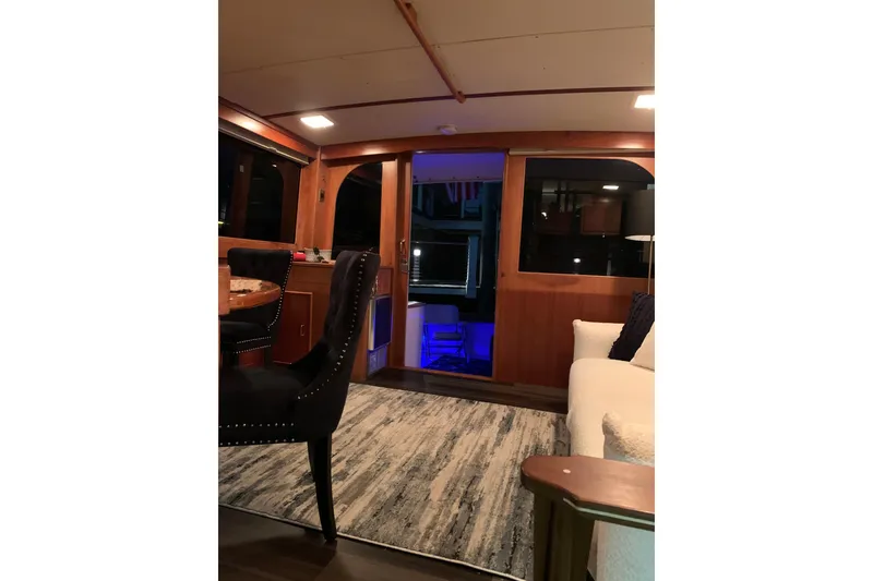 Slide: The Image of Luxurious interior of a 1985 Post 43 Convertible yacht with elegant wood finishes. - 8