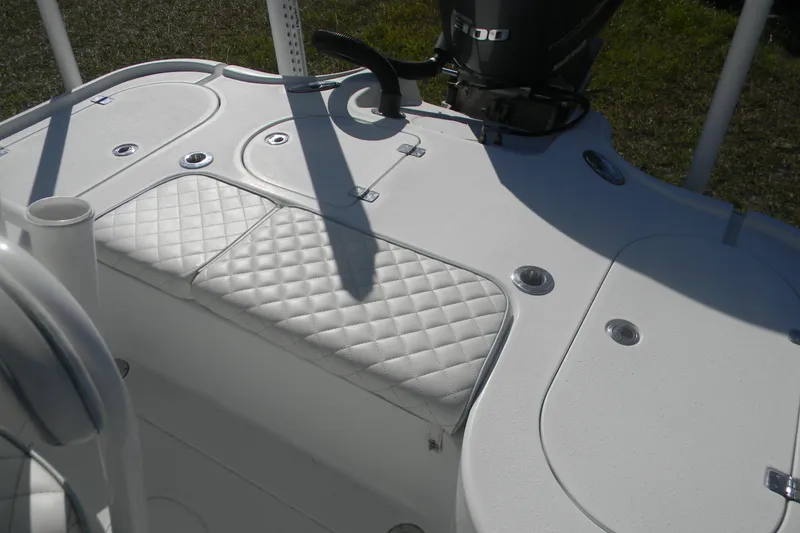 Slide: The Image of 2015 Yellowfin 24 Bay boat with white quilted seating and steering wheel. - 12