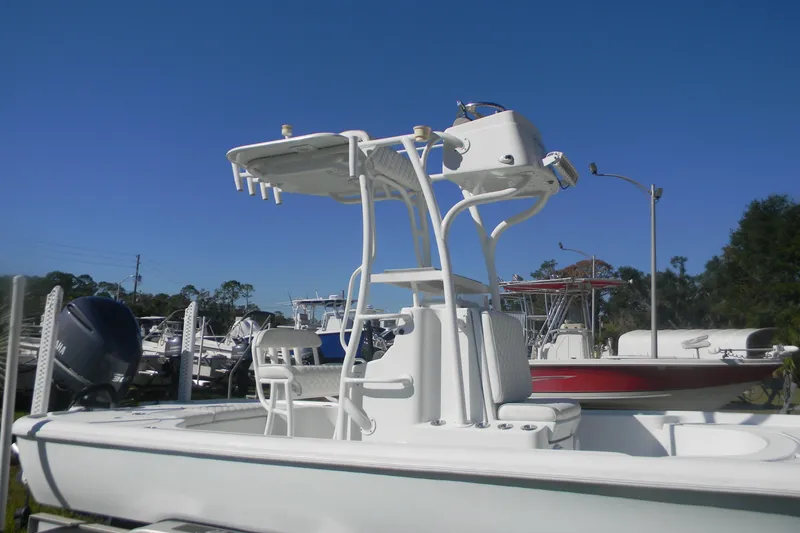 Slide: The Image of 2015 Yellowfin 24 Bay boat with T-top and seating, displayed outdoors. - 14