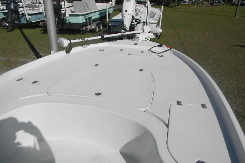 Slide: The Image of 2015 Yellowfin 24 Bay boat interior with cushioned seating and speakers. - 7