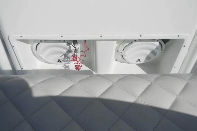Slide: The Image of 2015 Yellowfin 24 Bay boat T-top with rod holders against blue sky. - 9