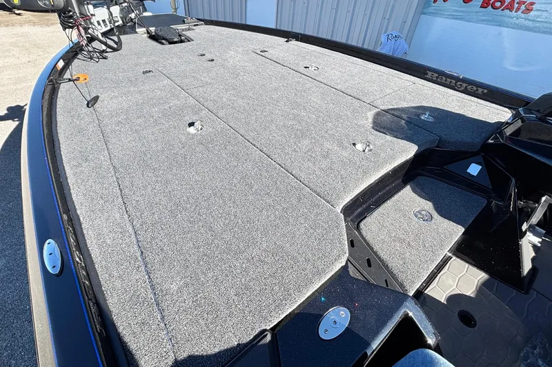 Slide: The Image of 2026 Ranger Z521 boat deck with gray carpet and storage compartments. - 4