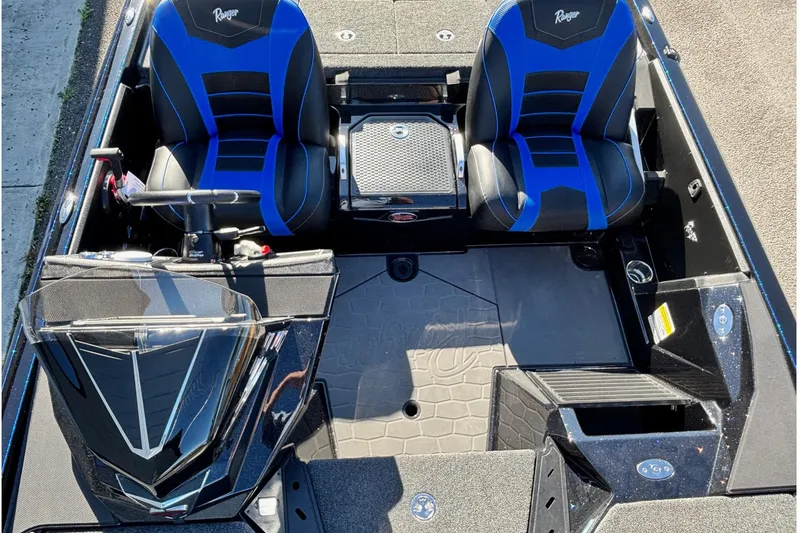 Slide: The Image of 2026 Ranger Z521 boat interior with blue and black seats, steering console, and storage compartments. - 7