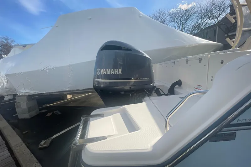Slide: The Image of 2018 Grady-White Freedom 235 boat with Yamaha outboard motor, covered in protective wrap. - 14