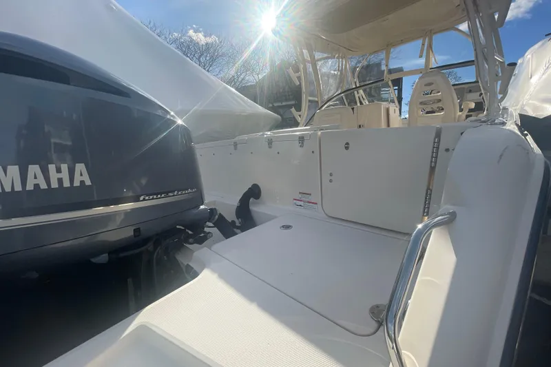 Slide: The Image of 2018 Grady-White Freedom 235 boat with Yamaha four-stroke engine, sunlit deck view. - 15