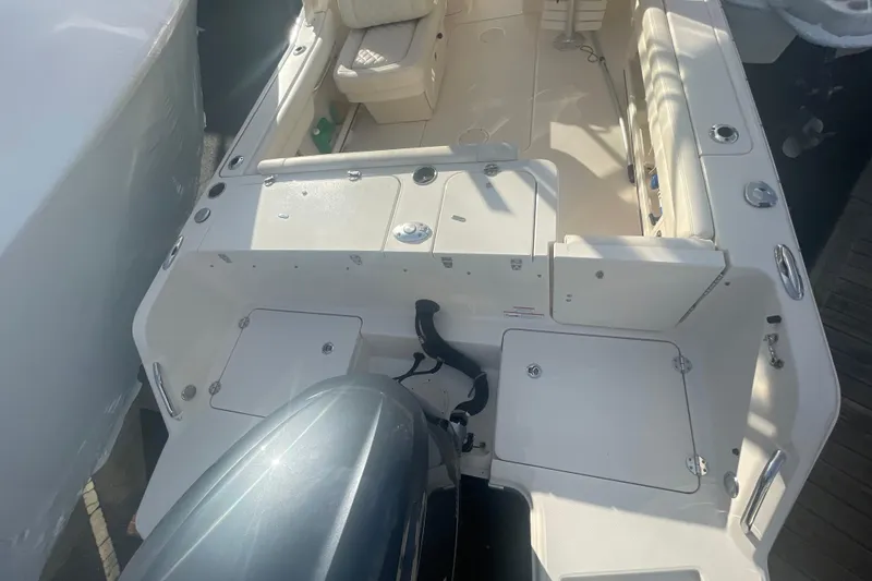 Slide: The Image of 2018 Grady-White Freedom 235 boat interior with seating and storage compartments. - 16