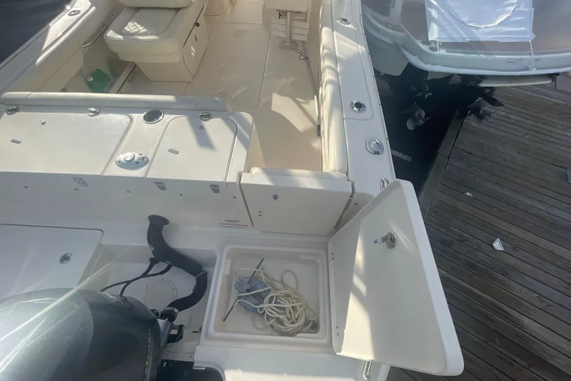 Slide: The Image of 2018 Grady-White Freedom 235 boat interior with seating and storage compartments. - 17