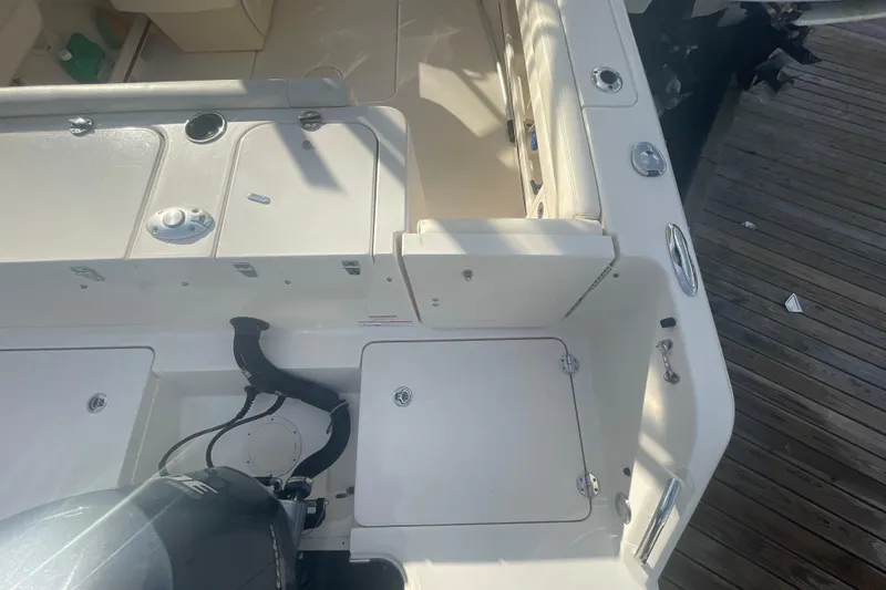Slide: The Image of 2018 Grady-White Freedom 235 boat interior with engine and deck details. - 18