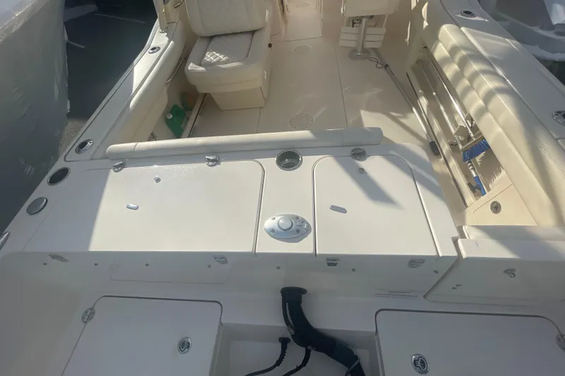Slide: The Image of 2018 Grady-White Freedom 235 boat interior with seating and storage compartments. - 21