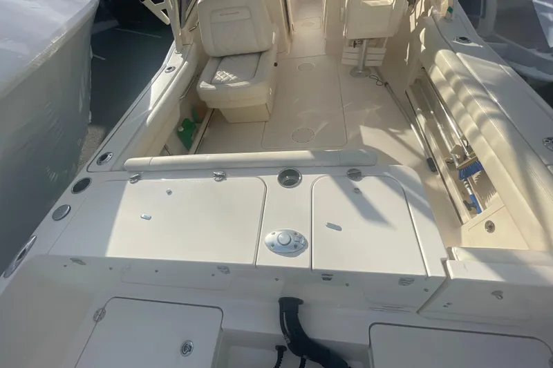 Slide: The Image of 2018 Grady-White Freedom 235 boat interior, featuring seating and storage compartments. - 22