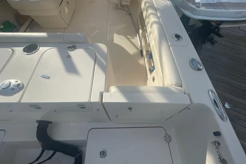 Slide: The Image of 2018 Grady-White Freedom 235 boat interior with seating and storage compartments. - 23