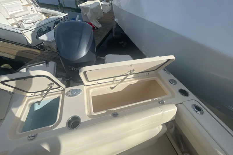 Slide: The Image of 2018 Grady-White Freedom 235 boat with open storage compartments and Yamaha 300 engine. - 29