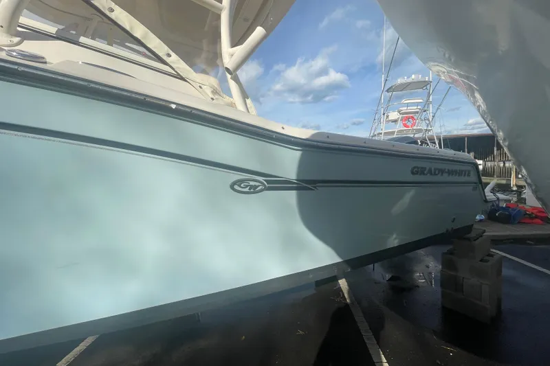 Slide: The Image of 2018 Grady-White Freedom 235 boat docked under clear blue sky. - 3