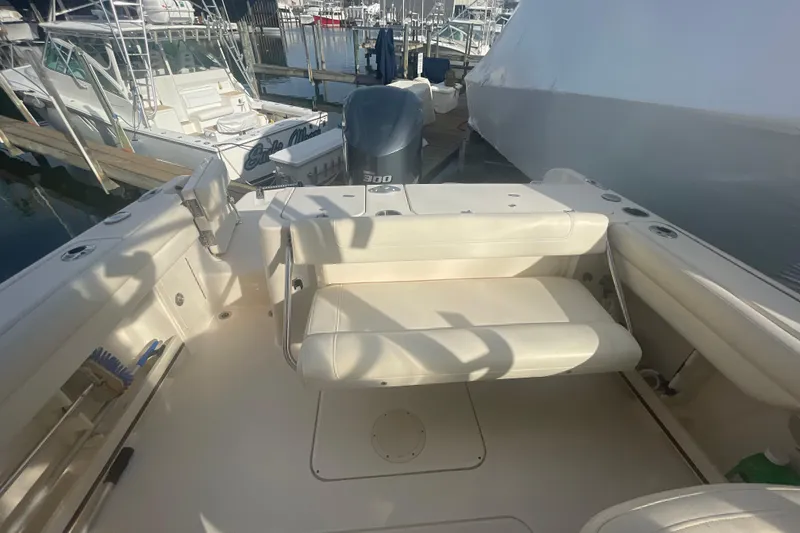 Slide: The Image of 2018 Grady-White Freedom 235 boat interior with seating and docked at marina. - 34