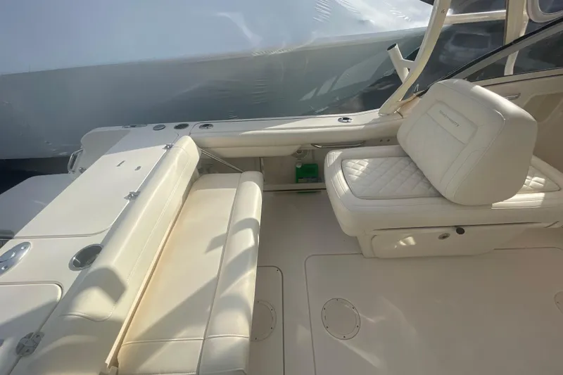Slide: The Image of 2018 Grady-White Freedom 235 boat interior with white cushioned seating. - 35