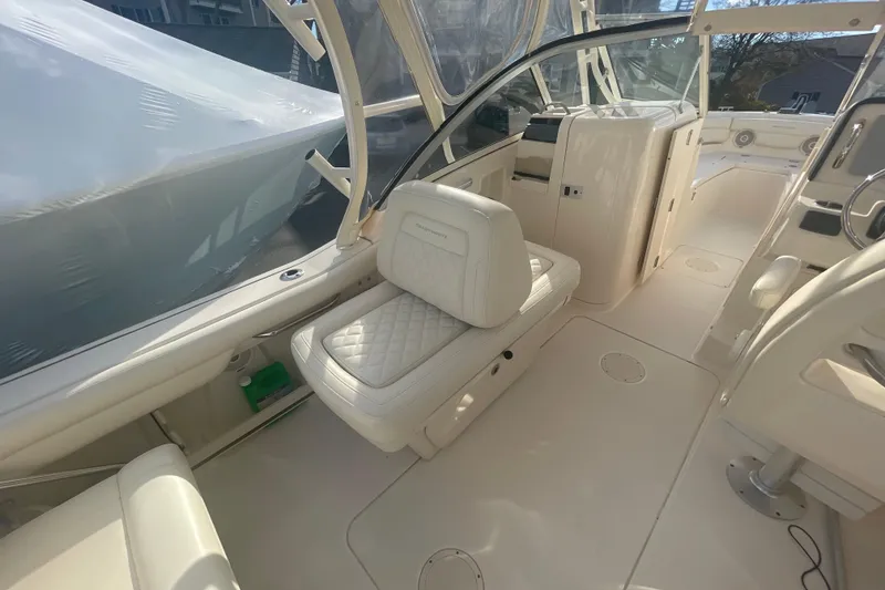 Slide: The Image of 2018 Grady-White Freedom 235 boat interior with cushioned seating and helm area. - 36