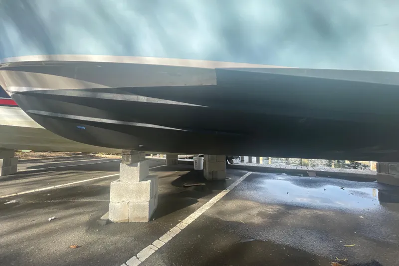 Slide: The Image of 2018 Grady-White Freedom 235 boat on cinder blocks in a parking lot. - 4