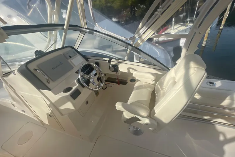 Slide: The Image of 2018 Grady-White Freedom 235 boat interior with steering wheel and Garmin navigation system. - 42
