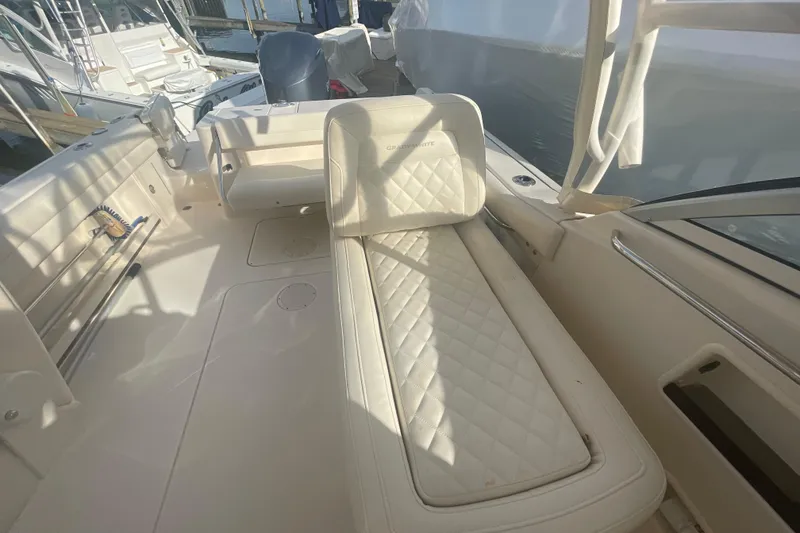 Slide: The Image of 2018 Grady-White Freedom 235 boat interior with cushioned seating and storage. - 44