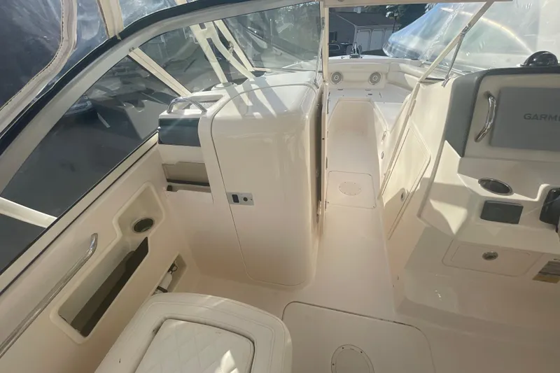 Slide: The Image of 2018 Grady-White Freedom 235 boat interior with helm and seating area. - 47