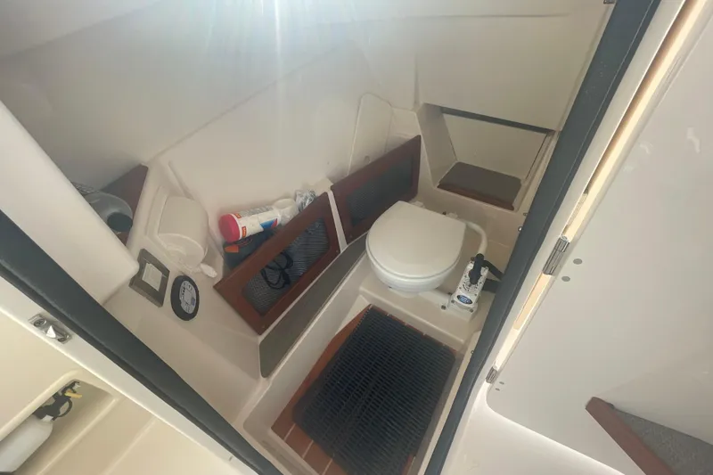 Slide: The Image of 2018 Grady-White Freedom 235 boat interior with toilet and storage compartments. - 48