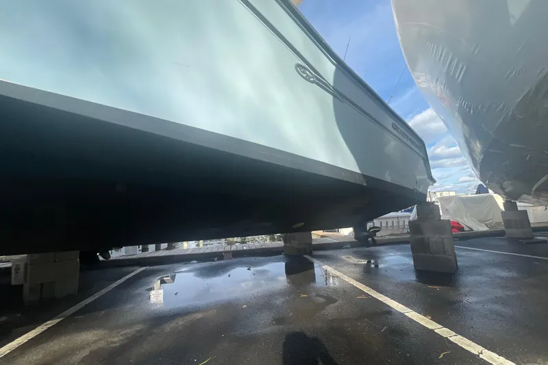 Slide: The Image of 2018 Grady-White Freedom 235 boat on blocks, side view, outdoor storage. - 5