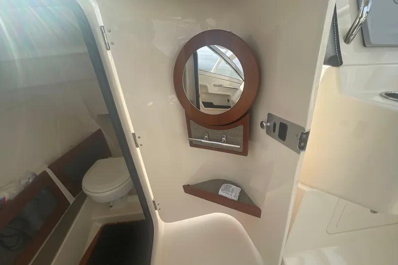 Slide: The Image of Interior of 2018 Grady-White Freedom 235 boat with toilet and mirror. - 50