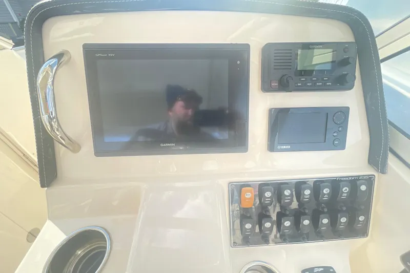 Slide: The Image of Control panel of 2018 Grady-White Freedom 235 boat with Garmin and Yamaha displays. - 55