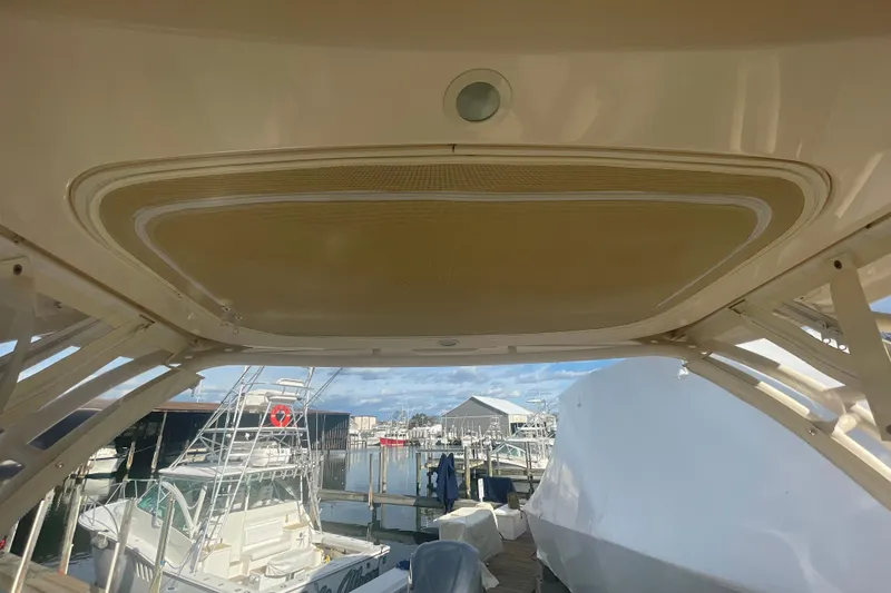 Slide: The Image of 2018 Grady-White Freedom 235 boat docked at marina, view from under the canopy. - 59
