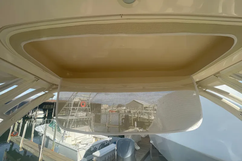 Slide: The Image of 2018 Grady-White Freedom 235 boat interior with marina view through rear window. - 60