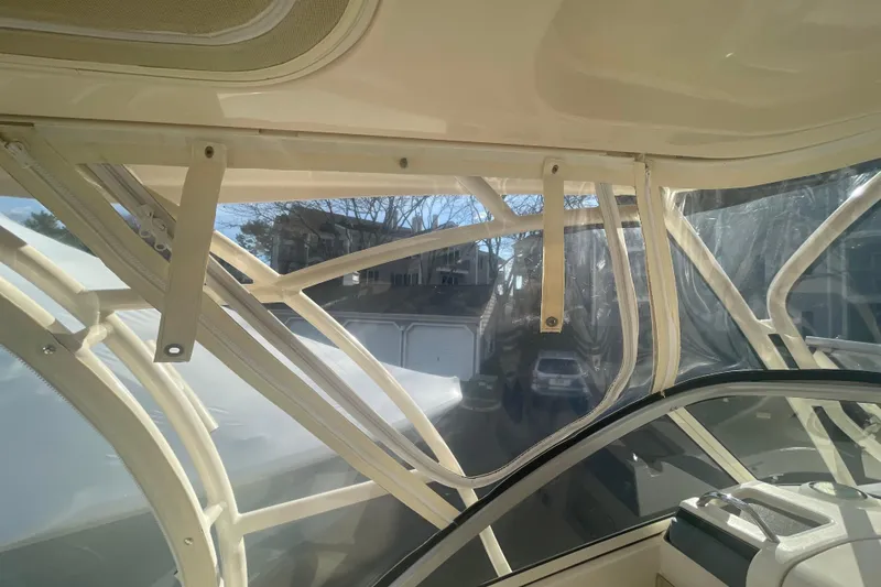 Slide: The Image of 2018 Grady-White Freedom 235 boat interior with clear enclosure and support structure. - 61