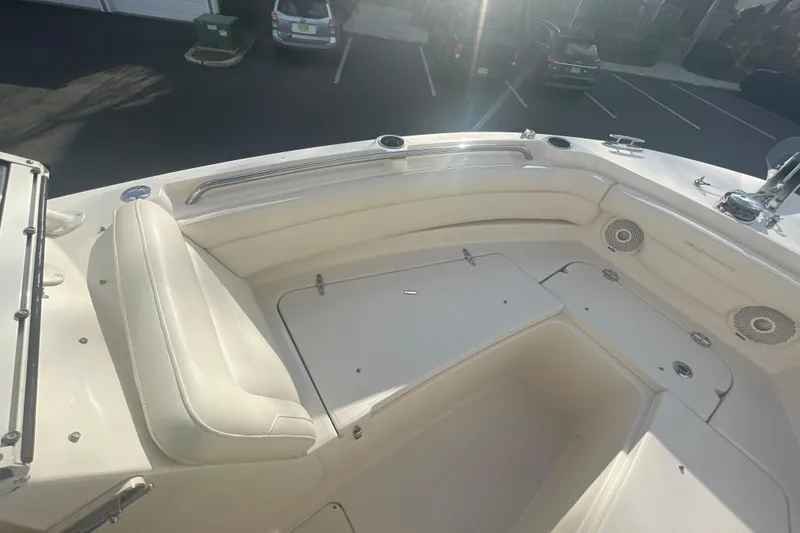 Slide: The Image of 2018 Grady-White Freedom 235 boat interior with cushioned seating and storage compartments. - 71