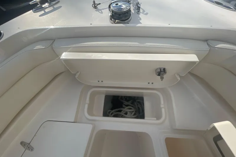 Slide: The Image of 2018 Grady-White Freedom 235 boat interior with storage compartments and seating. - 77