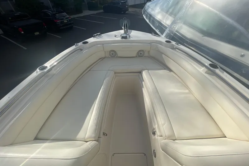 Slide: The Image of 2018 Grady-White Freedom 235 boat interior with white cushioned seating. - 79