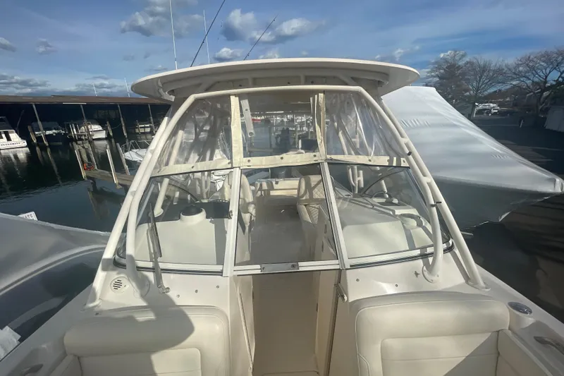 Slide: The Image of 2018 Grady-White Freedom 235 boat docked at marina under clear skies. - 80