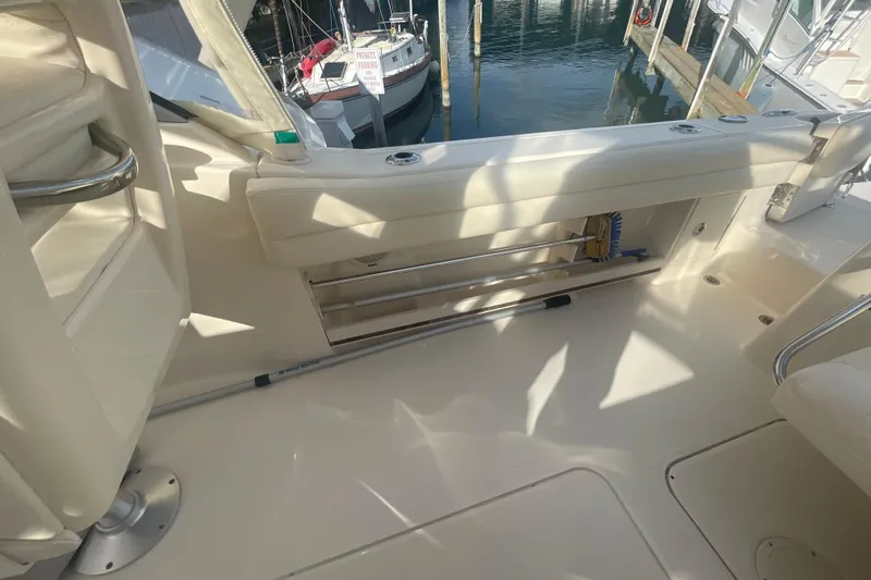 Slide: The Image of 2018 Grady-White Freedom 235 boat interior with storage compartment and dock view. - 84