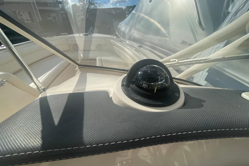 Slide: The Image of 2018 Grady-White Freedom 235 boat interior with compass and windshield view. - 85