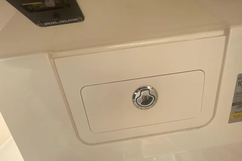 Slide: The Image of 2018 Grady-White Freedom 235 boat compartment with lock and breaker isolator. - 87