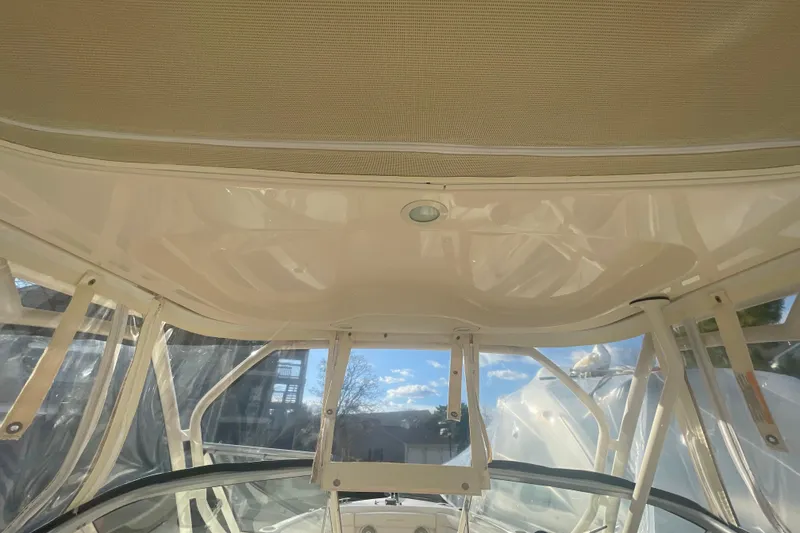 Slide: The Image of 2018 Grady-White Freedom 235 boat interior with clear canopy and sunny sky view. - 89