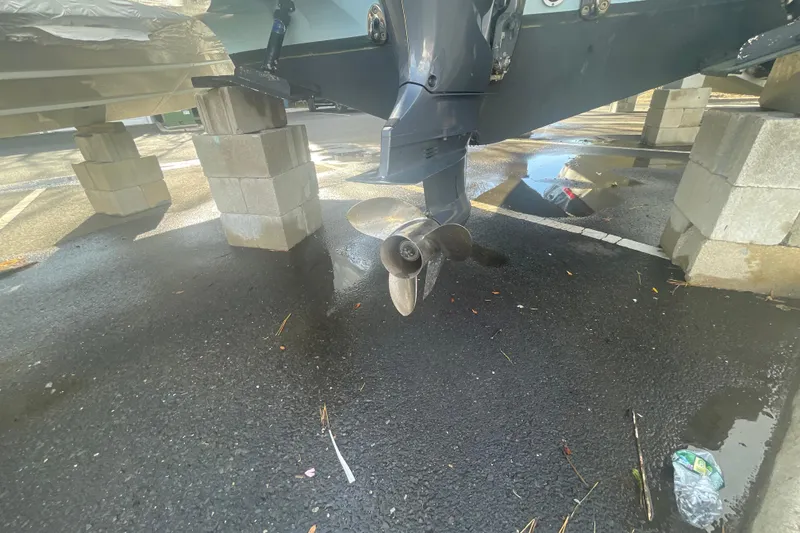 Slide: The Image of 2018 Grady-White Freedom 235 boat propeller on cinder blocks, asphalt surface. - 9