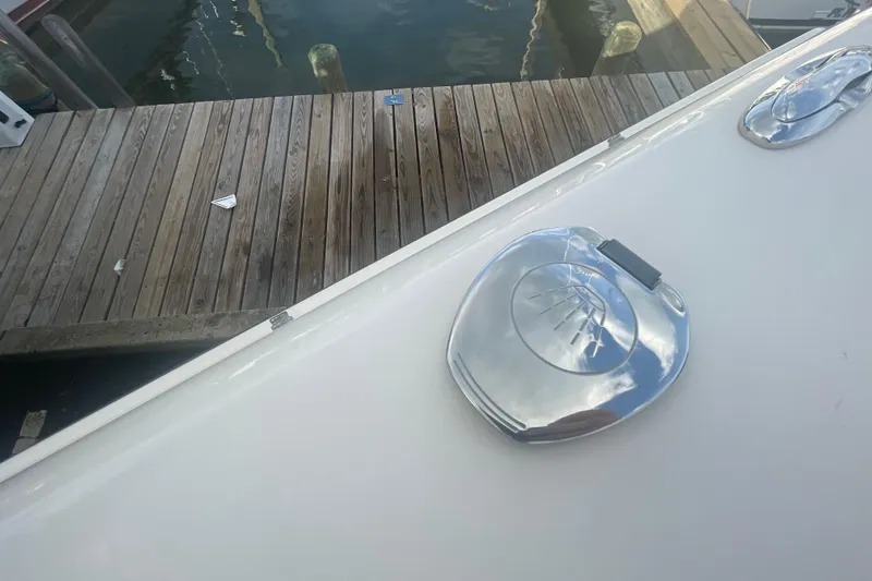 Slide: The Image of 2018 Grady-White Freedom 235 boat detail near wooden dock. - 91