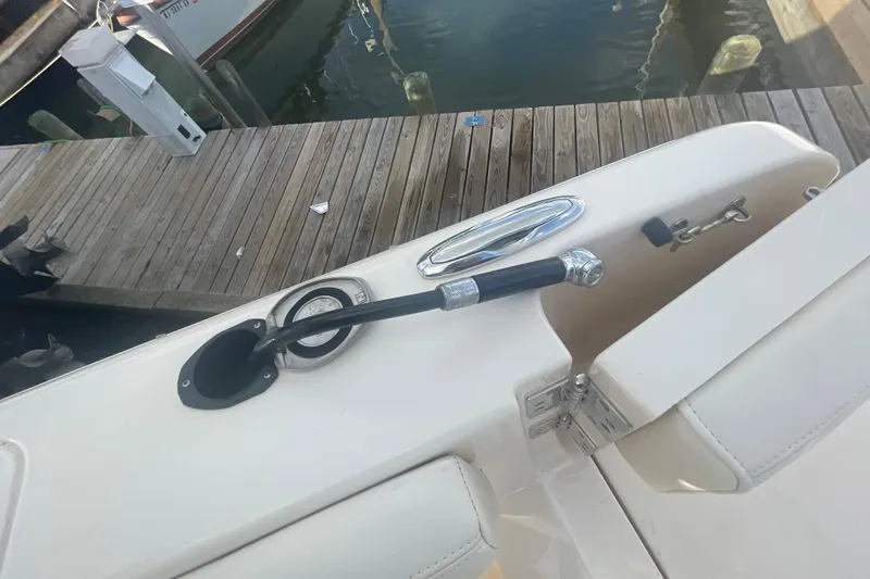 Slide: The Image of 2018 Grady-White Freedom 235 boat detail at dock, showing cleat and hose connection. - 92