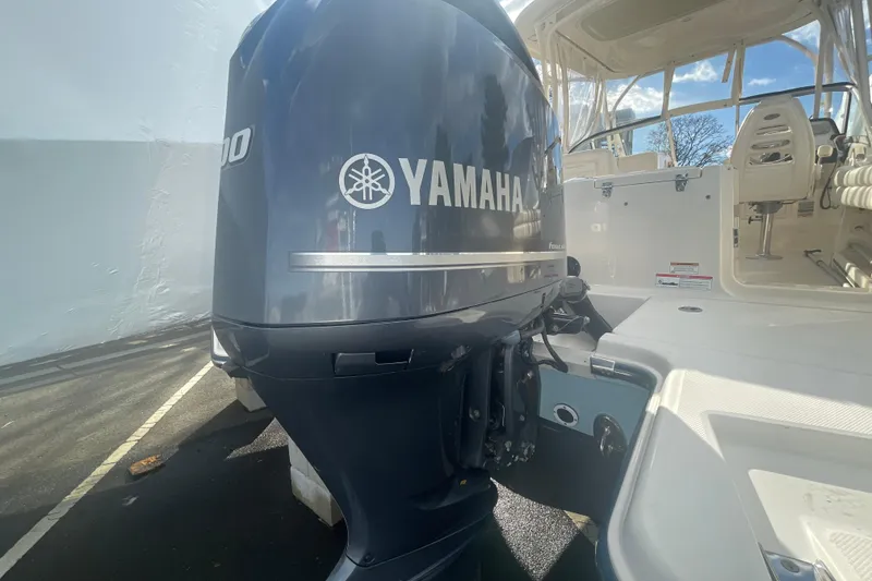 Slide: The Image of 2018 Grady-White Freedom 235 boat with Yamaha outboard motor, docked under clear skies. - 93