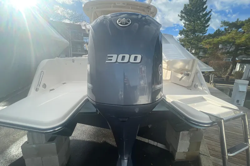 Slide: The Image of 2018 Grady-White Freedom 235 boat with a 300 horsepower engine, docked outdoors. - 94