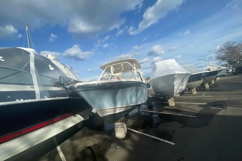 Slide: The Image of 2018 Grady-White Freedom 235 boat in storage, surrounded by other covered boats. - 97