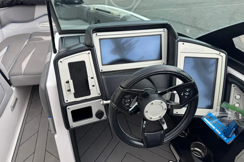Slide: The Image of 2020 Supra SL 575 boat dashboard with steering wheel and digital displays. - 6